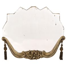 an ornate mirror with tassels on the sides