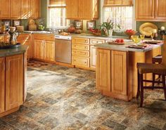 a kitchen filled with lots of wooden cabinets and counter top space next to an island