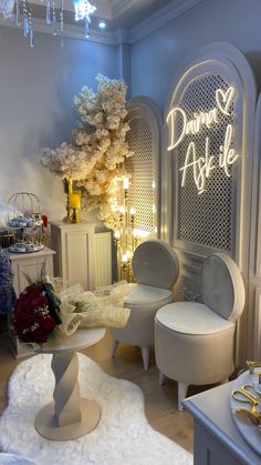 a room filled with white furniture and decorations