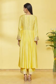 Mango kurta with floral embroidery on bodice and sleeve hem. Paired with palazzo and dupatta.
Component: 3
Pattern: Embroidery
Type Of Work: Floral
Neckline: Round
Sleeve Type: Bell sleeves
Fabric: Kurta, Palazzo- Cotton Silk, Dupatta- Weaving 
Color: Yellow
Other Details: 
Box pleat kurta
Bird embellished placket
Closure: Palazzo: Front zipper
Occasion: Sangeet - Aza Fashions Kurta Embroidery, Yellow Kurta, Kurta Palazzo Set, Kurta Palazzo, Types Of Work, Palazzo Set, Embroidery Floral, Silk Dupatta, Box Pleats