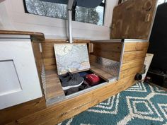 the inside of a camper that has been converted into a storage area for shoes and backpacks