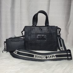 -Rare!! -Black Small Tote With Embossed With "Steve Madden" All Over The Bag And Has "Steve Madden" Logo Charm On The Front -Comes With Cotton Adjustable/Detachable Crossbody Strap With "Steve Madden " Logo On It And Has Two Handbag Handles - Has Matching Keychain Pouch -Bag Can Be Worn As A Crossbody Bag, Shoulder Bag, Or As A Handbag -Inside Bag Has Suede Like Material -One Zippered Wall Pocket Inside And One Sleeve Pocket Outside On The Front Of The Bag -Has Magnetic Snap Closure -Black Hardw Inside Bag, Matching Keychains, Handbag Handles, Small Tote, Wall Pockets, Mini Tote, Black Hardware, Pouch Bag, Inside Pocket