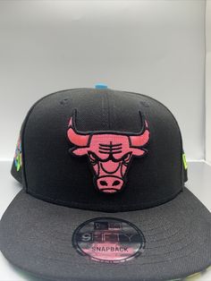 the chicago bulls black and pink snapback hat is on display in a white box