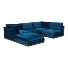 a blue sectional couch sitting on top of a white floor