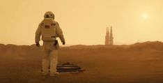 an astronaut walking in the desert towards a tower