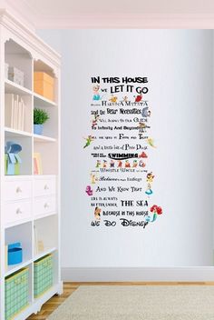 the wall sticker is in front of a white book shelf with shelves on it