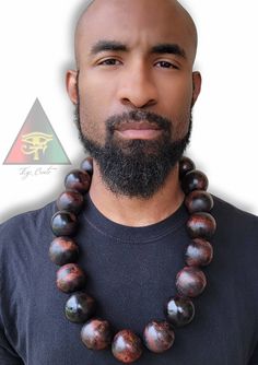 This 40mm Big Bead Wooden Necklace is hand crafted and painted by Eye Create LLC. This necklace is 30 inches in length (measured from the inside of the necklace). Make a statement without saying a word 💯 ✊🏾 PLEASE CONTACT ME FIRST BEFORE PURCHASING IF YOU HAVE A PERSONIZATION REQUEST!! Unique Hand Painted Brown Necklace, Artisan Hand Painted Brown Necklace, Artisan Brown Hand Painted Necklace, Create Llc, Bead Necklace For Men, Big Bead Necklace, Symbols Tattoos, African Inspired Jewelry, Warrior Necklace