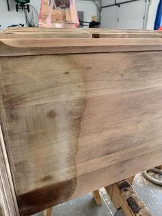 a wooden box sitting on top of a table in a room with tools and other items