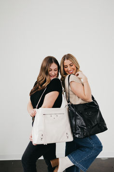 Discover your inner fashionista with the Tabitha Tote! This vegan leather tote offers two stylish looks with its ability to be worn as either a shoulder or crossbody bag. It has beautiful and edgy exterior hardware and two long zipper tassels for a fun and fresh look. Whether you're traveling, hitting the town, or just running errands, this accessory is perfect. The interior and exterior pockets make it easy to access your essentials and allows you to carry all your necessities! Vegan Leather Tote, Fashion Tote Bag, Crochet Poncho, Short Sleeve Cardigan, Fresh Look, Long Tops, Running Errands, Leather Tote, Sweater Hoodie