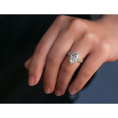 a woman's hand with a diamond ring on it