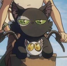 two cats are sitting on the back of a person's shoulder and one cat is standing behind them