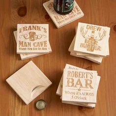 four wooden coasters on a table with a beer bottle in the middle and other personalized coasters