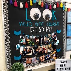 a bulletin board with pictures and tassels hanging on it's side that says look who got caught reading