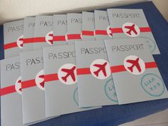 six passport stickers with red and white arrows on them are sitting next to each other