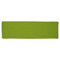 a bright green knitted placemat on a white background with clipping for text