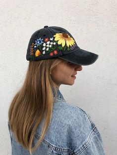 Hand Embroidered Hat is the best gift for her!🌿 PLEASE NOTE I NEED 2 WEEKS TO EMBROIDER THIS HAT FOR YOU🌿Color: a black baseball cap.Design: hand embroidered echinacea with wildflowers.Cap size (head circumference): 55 - 62 cm.GET 10% OFF YOUR 1ST ORDER!Get a 10% off coupon code for our Etsy shop by signing up to our mailing listeepurl.com/gefZy5CHECK OUR OTHER ACCESSORIES🌸More Baseball hats:https://www.etsy.com/shop/KazkovaEmbroidery?ref=seller-platform-mcnav&section_id=25392998🌿Kids Ba Embroidered Adjustable Trucker Hat, Embroidered Multicolor Cap, Multicolor Embroidered Cap, Embroidered Flower Baseball Cap, One Size, Embroidered Trucker Hat With Curved Brim, Embroidered Baseball Cap One Size, Adjustable Snapback Hat With Floral Embroidery, Embroidered Baseball Cap One Size Fits Most, Embroidered Visor Hat