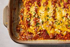 a casserole dish with meat, cheese and sauce