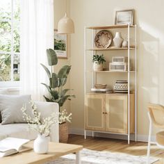 a living room filled with furniture next to a white couch and wooden table in front of a window