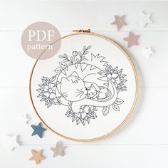 a cross stitch pattern with an elephant and cat in the center surrounded by stars on a white background