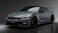 a grey sports car with red stripes on the hood is shown in this studio shot