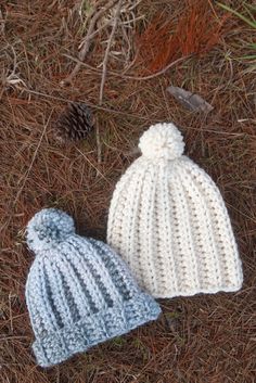 two knitted hats laying on the ground