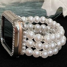 Custom, handmade, beaded watch band compatible with Apple Watch made with imitation pearls and rhinestone beads.  *Other colors available upon request: Gold, Black, Hot Pink, Red, Royal Blue, Aqua, Light Green, Green, Light Purple, and Purple. Please use the drop-down to select your connector and wrist size. I can also make one custom to your wrist measurement if you include your wrist size in your order (example in last photo). I have many different colors/styles/materials of beads. If you are looking for a specific color please send me a message and I may have it! These are handmade items so they may vary in pattern placement. Due to differences in screen settings, colors may differ slightly between photos and the physical product. Please feel free to send me a message if you have questi Elegant Beaded Apple Watch Band As Gift, White Beaded Apple Watch Band Gift, White Beaded Apple Watch Band For Gift, White Beaded Apple Watch Band As Gift, Elegant Adjustable Beaded Watch Bands, Turquoise Watch Band, Black And Gold Watch, Pearl Watch, Christmas Watches