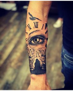 a man's arm with an all seeing eye tattoo on it