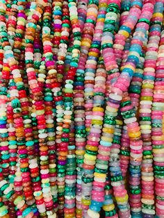 multicolored beads are stacked on top of each other