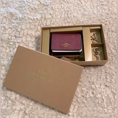 This Nib/Nwt Coach Gift Set Boasts A Mini Black Cherry Colored Wallet With A Detachable Gold Chain And Detachable Charms. Such A Great Gift! The Wallet Can House Change, Ids, Money, Cards. 4”X3” Out Of Stock In Stores And Online! Black Cherry Color, Cherry Color, Coach Gift, Money Cards, Coach Gifts, Black Cherry, Red Gold, Coach Bags, Gold Chain