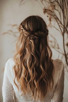 the back of a woman's head with long, wavy hair