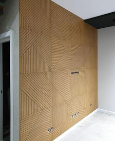 the wall is made out of wood and has geometric designs on it