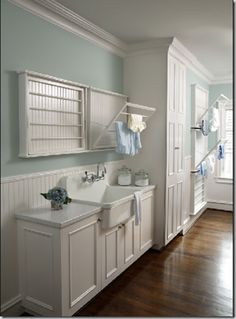 an image of a bathroom with white cabinets and green towels on the rack above the sink