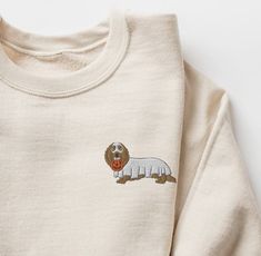 Super cute EMBROIDERED Dachshund Halloween Unisex Sweatshirt. A sturdy and warm sweatshirt bound to keep you warm in the colder months. A pre-shrunk, classic fit sweater that's made with air-jet spun yarn for a soft feel and reduced pilling. * 50% cotton, 50% polyester * Pre-shrunk * Classic fit * 1x1 athletic rib knit collar with spandex * Air-jet spun yarn with a soft feel and reduced pilling * Double-needle stitched collar, shoulders, armholes, cuffs, and hem This product is made especially f Long Sleeve Cotton Sweatshirt With Dog Print, Cotton Dog Print Sweatshirt For Fall, Fall Cotton Sweatshirt With Dog Print, Dachshund Halloween, Embroidered Halloween, Embroidered Dog, Ghost Dog, Halloween Dog, Dog Sweatshirt