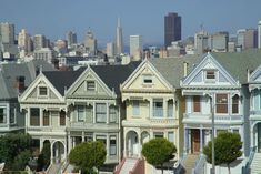 a row of houses with the city in the background