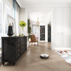 a living room filled with lots of furniture and walls covered in white painted trimming