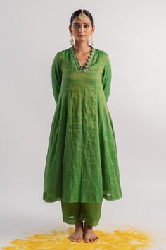 Green tissue A-line kurta with sequins hand embroidered neckline and sleeve hems. Comes with pant.
Components: 2
Pattern: Hand embroidered
Type Of Work: Sequins
Neckline: V Neck
Sleeve Type: Three quarter
Fabric: Tissue
Color: Green
Other Details: 
Scalloped detailing on kurta
Occasion: Puja - Aza Fashions V Neck A Line Kurta, A Line Suits Indian, Tissue Fabric Dress Design, Tissue Dress Designs, A Line Kurti Designs, Tissue Kurta, Kurta And Dupatta, Cotton Tops Designs, Silk Anarkali Suits