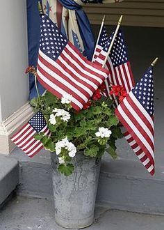 flowers and flags are placed on the front porch