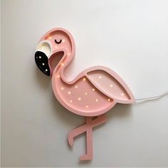 a pink light up flamingo with its eyes closed