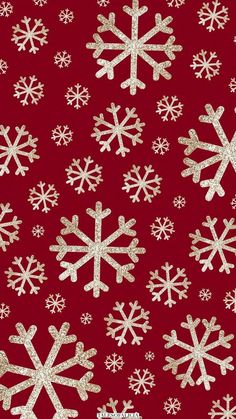 red and white snowflakes with gold glitters on the bottom, against a dark red background