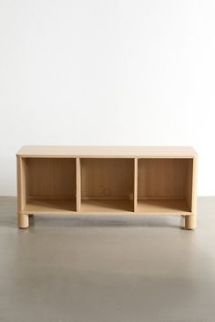 a wooden shelf sitting on top of a cement floor