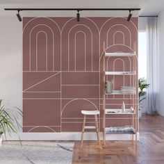 a living room with a pink wallpaper and white furniture in the corner, along with a wooden floor