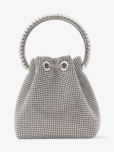 Our signature Mattea Crystal Embellished Bucket Bag In Silver is crafted from silver crystal. A statement accessory to love forever, it is finished with a sparkling crystal top handle and a sleek drawstring chain that cinches the supple shape. Take yours with you everywhere. Material: PU 6.5inch / 16.5cm diameter (dimensions approx.) Luxury Crystal Bag With Bling, Luxury Diamante Bags For Women, Luxury Evening Shoulder Bag With Metal Hardware, Luxury Elegant Shoulder Bag With Silver Accents, Luxury Metallic Bag With Zipper Closure, Luxury Metallic Bag With Detachable Handle, Luxury Evening Bag With Metal Hardware, Designer Metallic Silver Luxury Bag, Luxury Silver Bags For Shopping