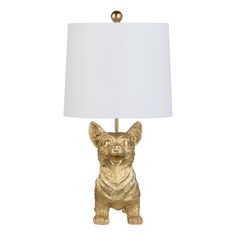 a gold dog lamp with a white shade