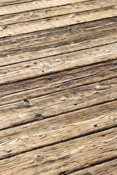 an old wooden deck with planks is shown