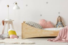 a child's bedroom with stars on the wall and a wooden bed in it