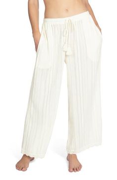 Lounge poolside in these textured wide-leg pants designed with a tassel-tie waist and lacy trim. Ties at waist Unlined 100% cotton Hand wash, dry flat Imported White Pants With Elastic Waistband And Tie-side, Vacation Cotton Bottoms With Tie Waist, Cotton Tie Waist Bottoms For Vacation, White Cotton Wide Leg Pants For Vacation, White Tie Waist Beach Pants, White Tie-side Bottom Pants For Spring, White Beach Pants With Tie Waist, Cotton Wide Leg Pants With Tie Waist For Loungewear, Chic Tassel Pants For Spring