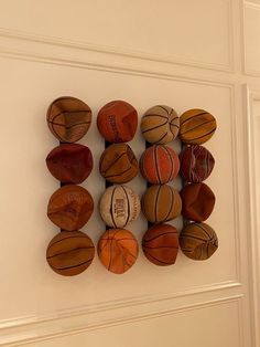 several basketballs are mounted to the wall