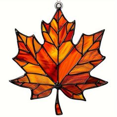 a stained glass maple leaf hanging from a chain