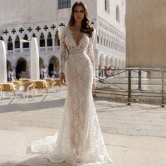 a woman in a wedding dress posing for the camera