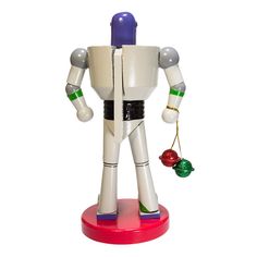 a toy robot is holding a christmas ornament